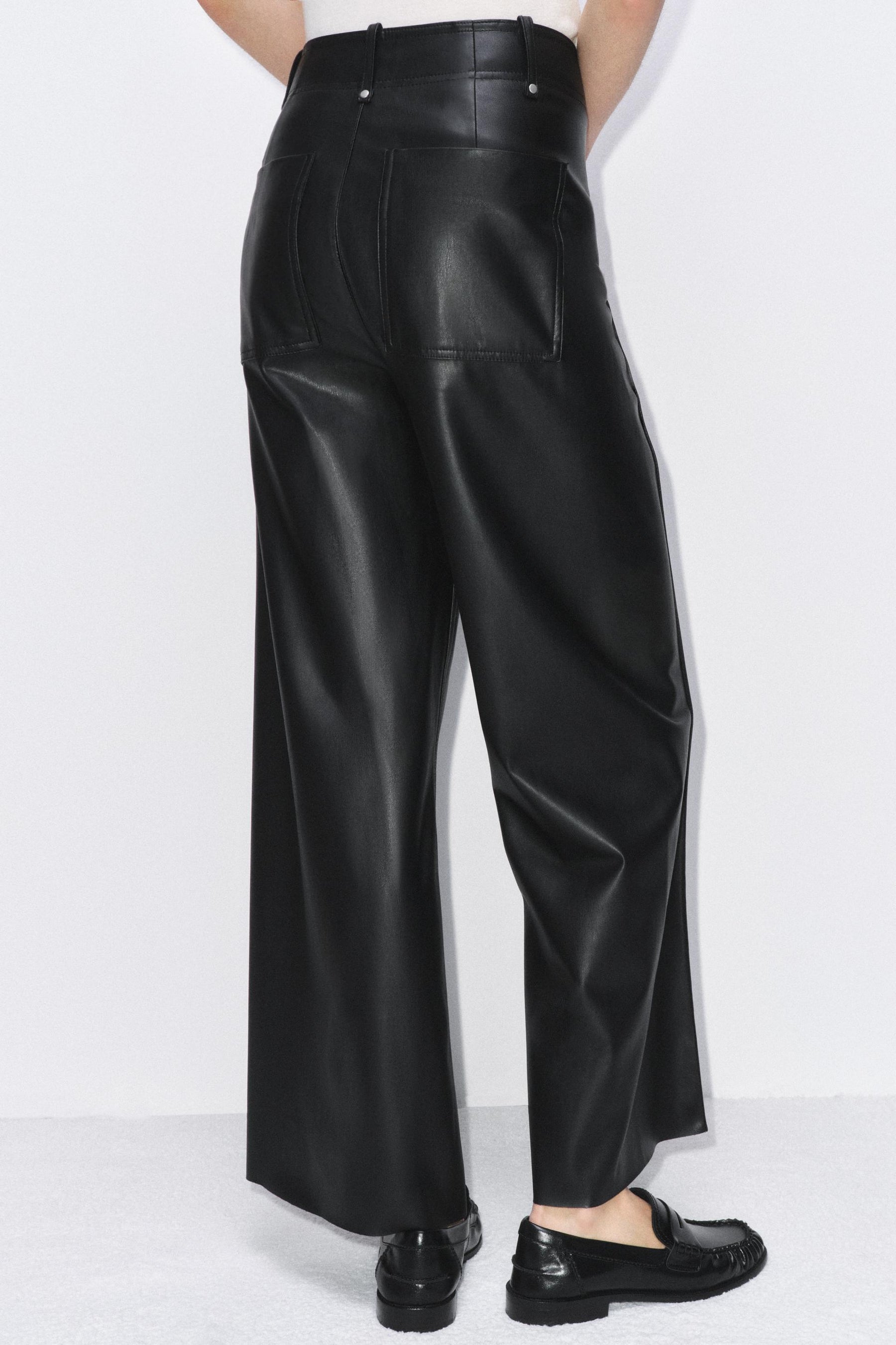 Tailored wide-leg leather-effect trousers.